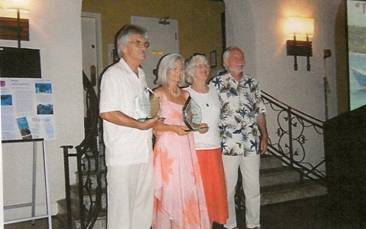 Paul G. Johnson and Dorothy Lee Witwer (president and vice president of Reef Relief) with the Quieros' present trophies of appreciation at the Annual Membership Meeting 2009. Location: Casa Marina Resort in Key West, Florida. 